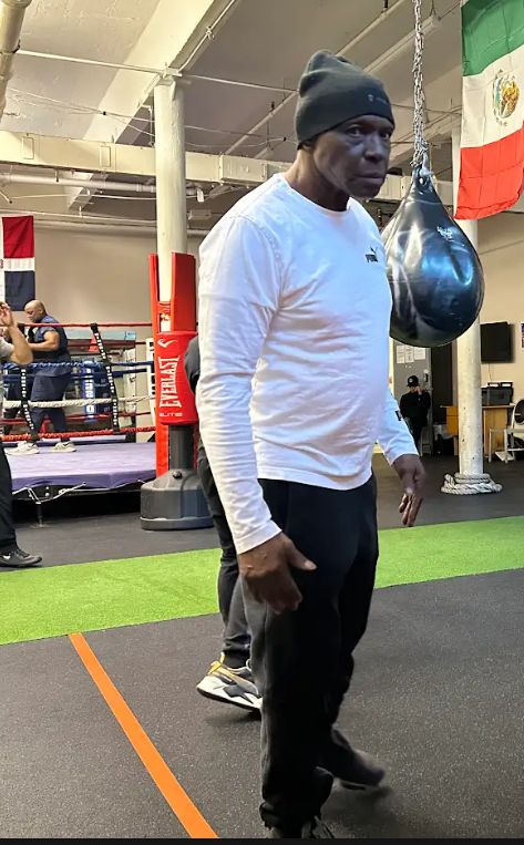 A Boxing N' More trainer standing in the gym in front of a speed bag